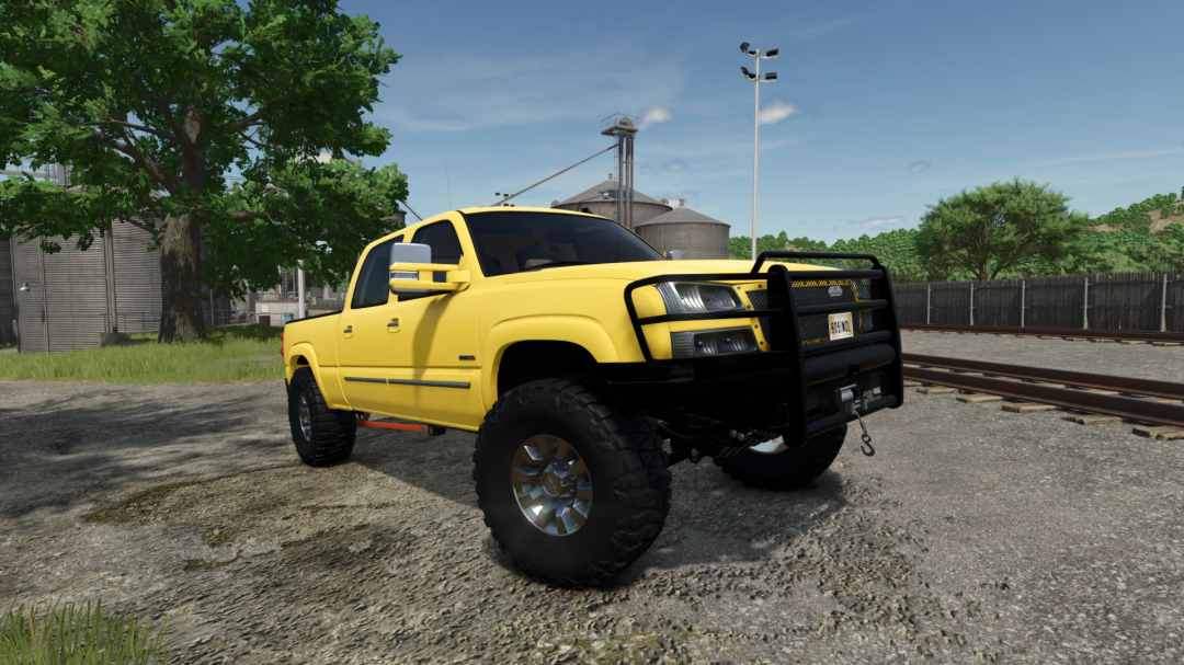 Yellow 2005 Chevy 3500 mod in FS25, parked on a dirt road with farm structures in the background.