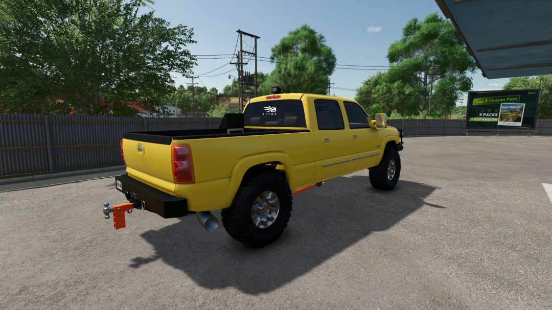 Yellow 2005 Chevy 3500 mod in FS25 with a lift kit and towing attachment.