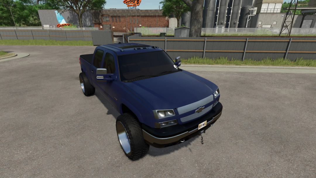 2005 Chevy 3500 mod in Farming Simulator 25, showcasing a blue pickup truck with custom wheels. FS25 mods enhance gameplay realism.