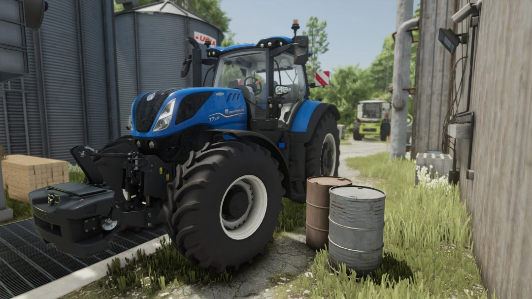 FS25 mod Diesel Barrel v1.0.0.0 showing blue tractor near barrels and farm buildings.