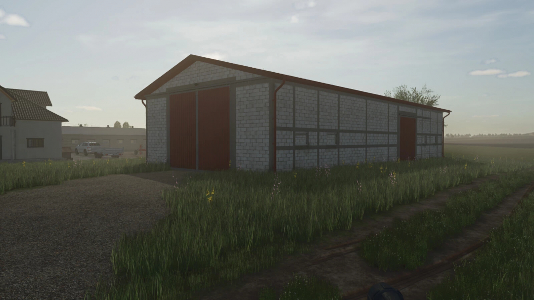 Grain Hall mod for Farming Simulator 25, showcasing a large barn on a grassy field. FS25 mods enhance farm storage.