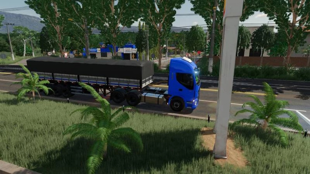 FS22 Iveco 440 Farias Chipped mod showcasing a blue truck with a covered trailer on a road in Farming Simulator 22.