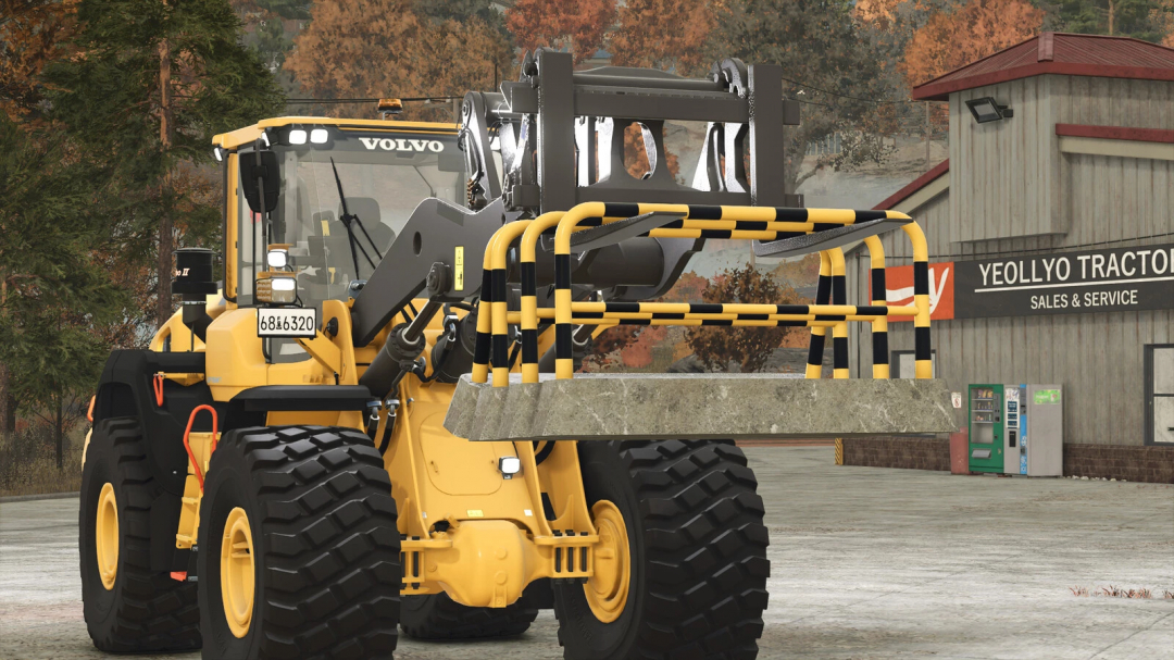 Yellow loader with Mobile Barrier mod in FS25 near tractor service building.