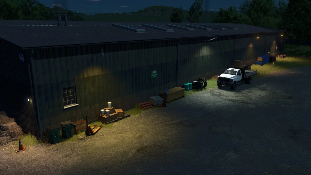 Placeable wall lights illuminate a storage building at night in FS25 mod.