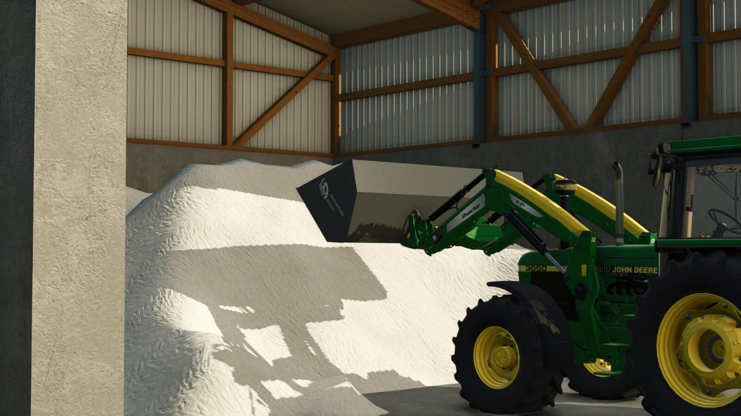 FS25 mod Roetterink Shovel Pack v1.0.0.0 in use with a green tractor in barn, lifting white material.