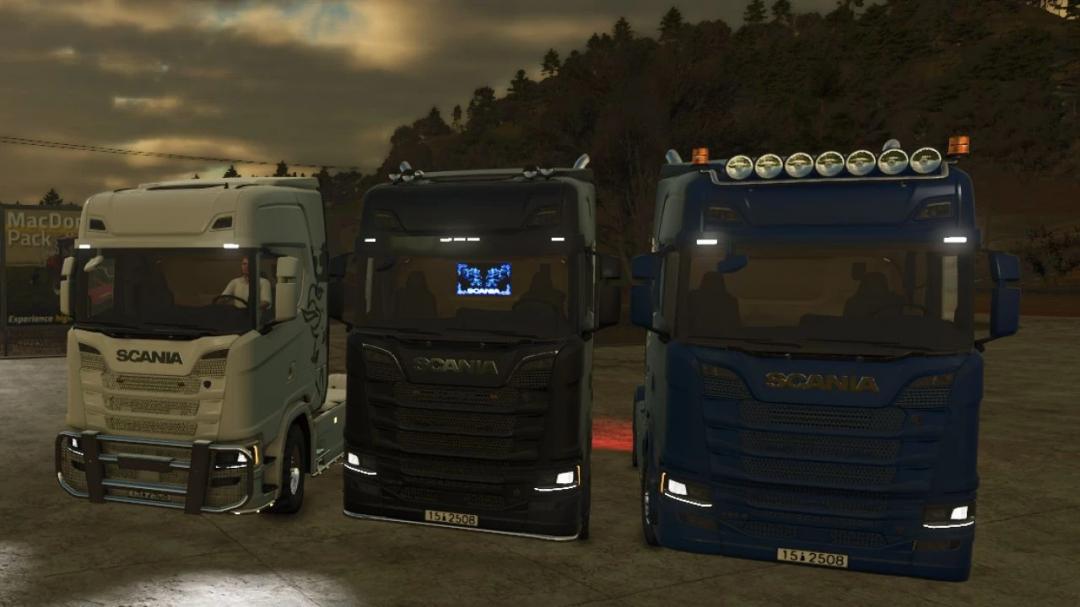 Three Scania S trucks in white, black, and blue from FS25 mods, parked side by side.