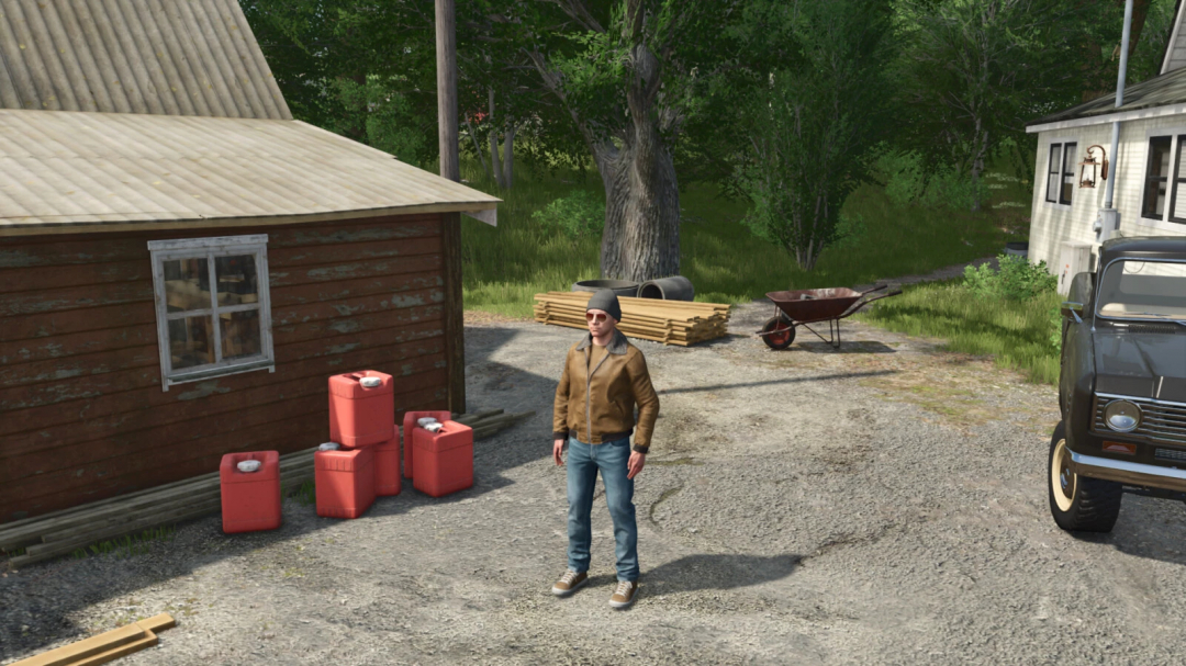 FS25 Silage Additive Drum mod with character standing by red drums in farm setting.