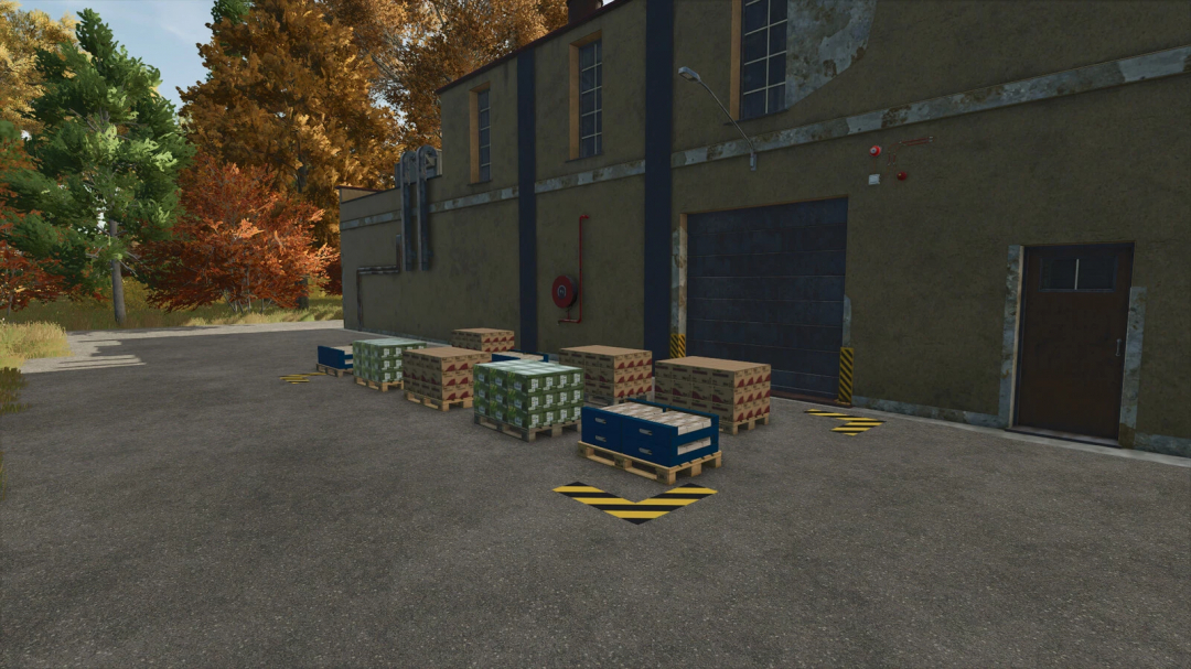 FS25 mods: Soybean Factory v1.0.0.0 showing pallets of goods outside a warehouse with fall foliage.