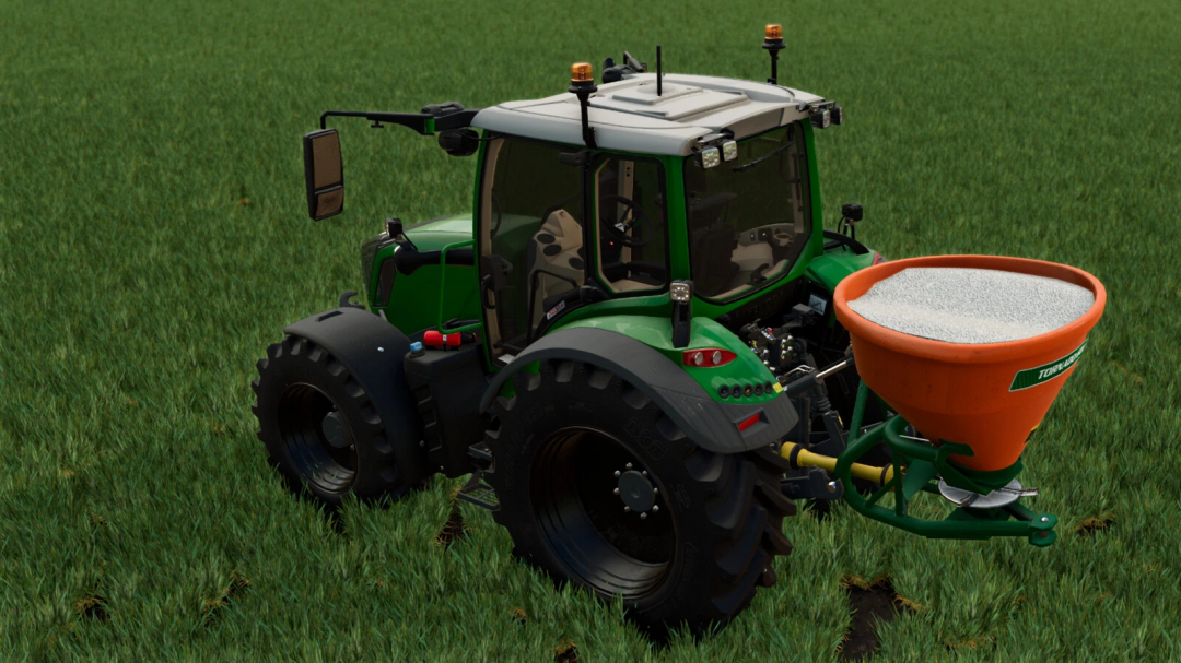 FS25 mod Stara Tornado 600 MD v1.0.0.0 fertilizer spreader on a green tractor in a field.