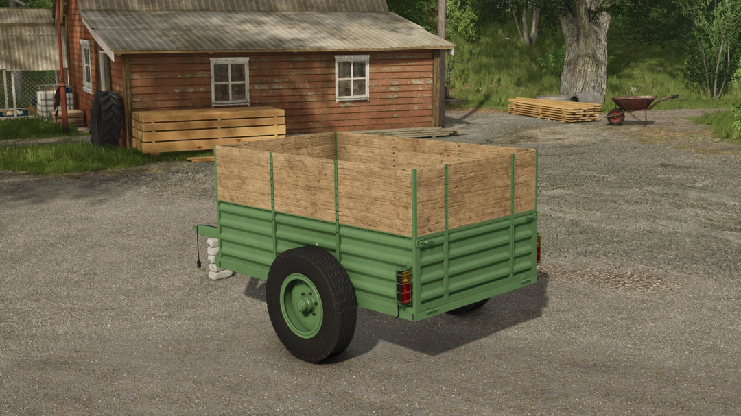 FS25 mod Two Wheel Trailer v1.0.0.0 in front of a rustic barn, showcasing its green and wooden design.