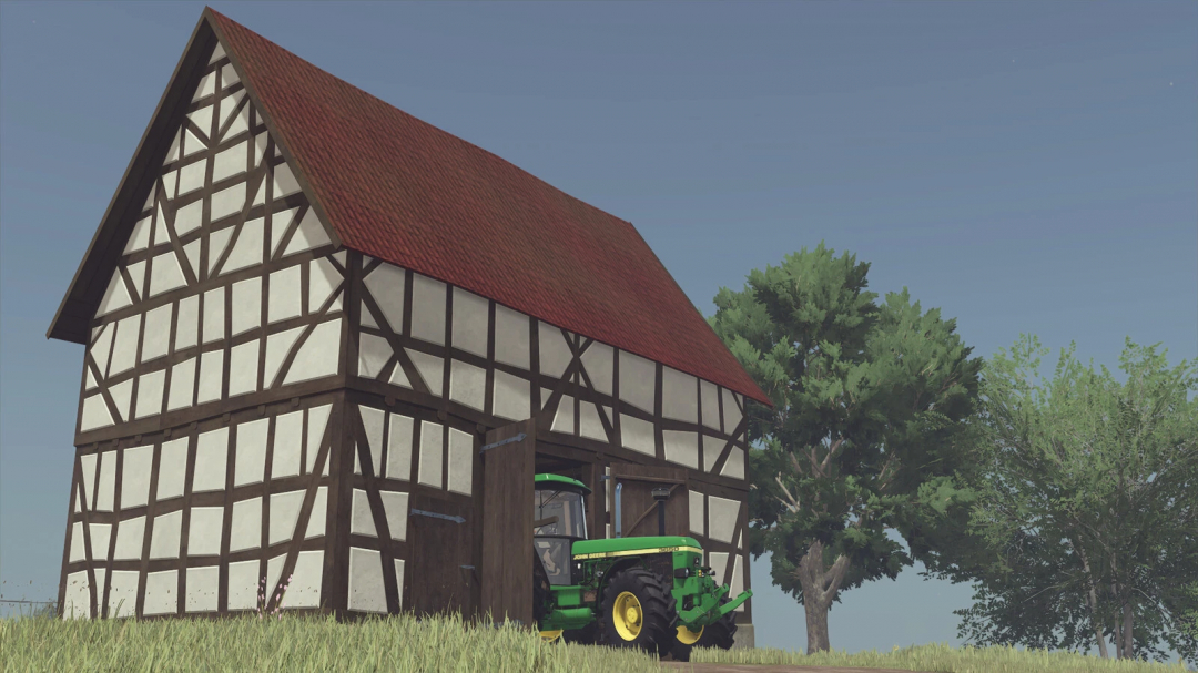 Screenshot of FS25 mod Very Old Timberframe Barn with a green tractor inside.