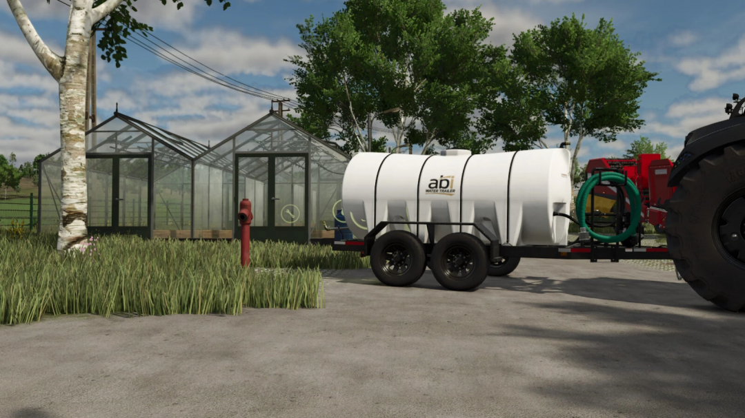 FS25 mods: Water Hydrants v1.0.0.0 features a water trailer next to greenhouses in Farming Simulator 25.