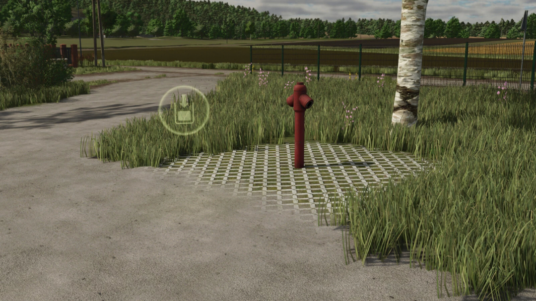 A red water hydrant mod in FS25 on a grassy path, enhancing Farming Simulator 25 gameplay.