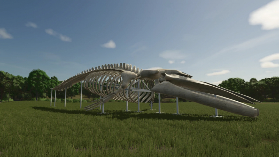 Whale skeleton sculpture mod in FS25, displayed on grassy field.