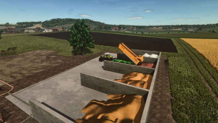 fs25-mods, Flat storage mod in FS25 with tractor unloading materials onto concrete bays in a rural landscape.