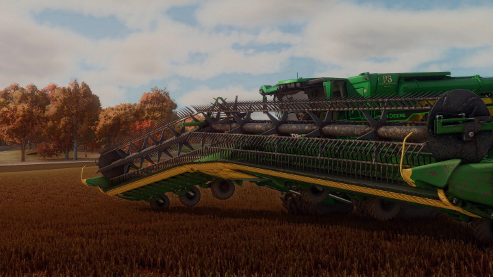 fs25-mods, Close-up of John Deere 45/62ft articulated pack mod in FS25 on a field, showcasing detailed machinery and autumn landscape.