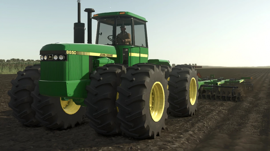 John Deere 8650 4WD mod for FS25, depicted on a field, showcasing its large tires and green design.