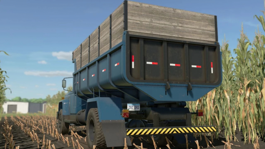 Lizard D14000 trailer mod in FS22, featuring a blue design parked in a cornfield.