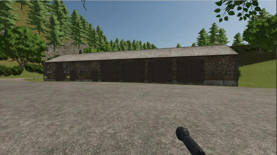 Old stone building mod in FS25, featuring rustic architecture and surrounded by trees.