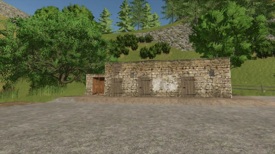 Old stone building mod in Farming Simulator 25 with trees and hills in the background.