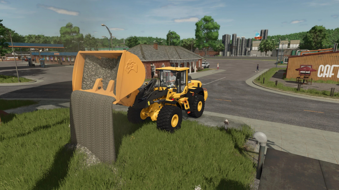 FS25 mods: Tip Anywhere v1.0.0.0 with a yellow loader dumping gravel in a field near a town.