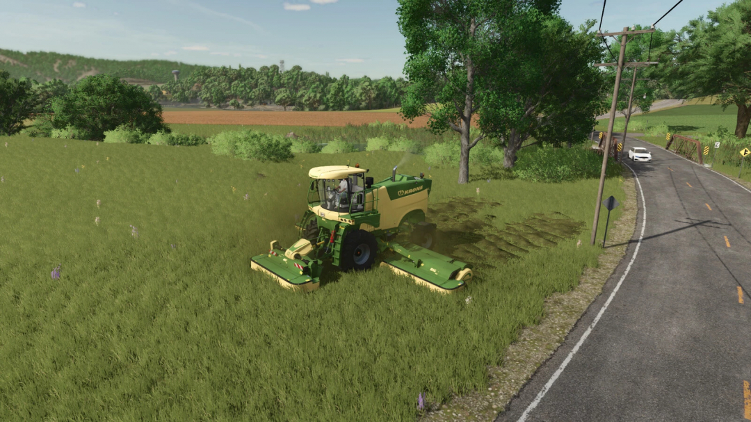 FS25 mod Tip Anywhere v1.0.0.0 showing a Krone harvester in a grassy field near a road.