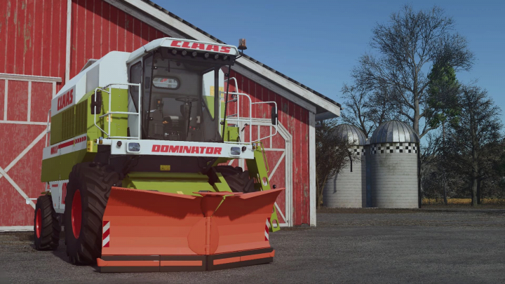 fs25-mods, Claas Dominator Snowbine mod in FS25, parked by a red barn, featuring a snowplow attachment.