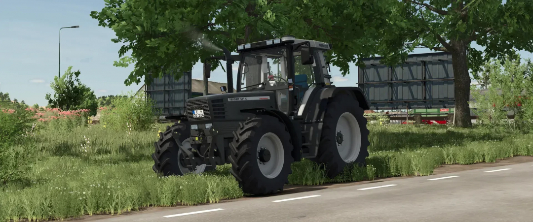 Fendt 500 Favorit tractor mod in FS25, parked on a rural road surrounded by lush greenery.