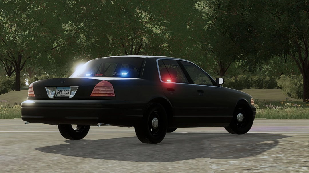 FS25 mod: Ford Crown Victoria Police Interceptor v1.0.0.0 parked on a road with lights flashing, set in a green forest environment.