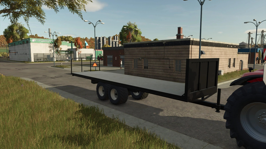 Homemade Bale Trailer mod in FS25 game, showcasing a black flatbed trailer in a rural town setting.