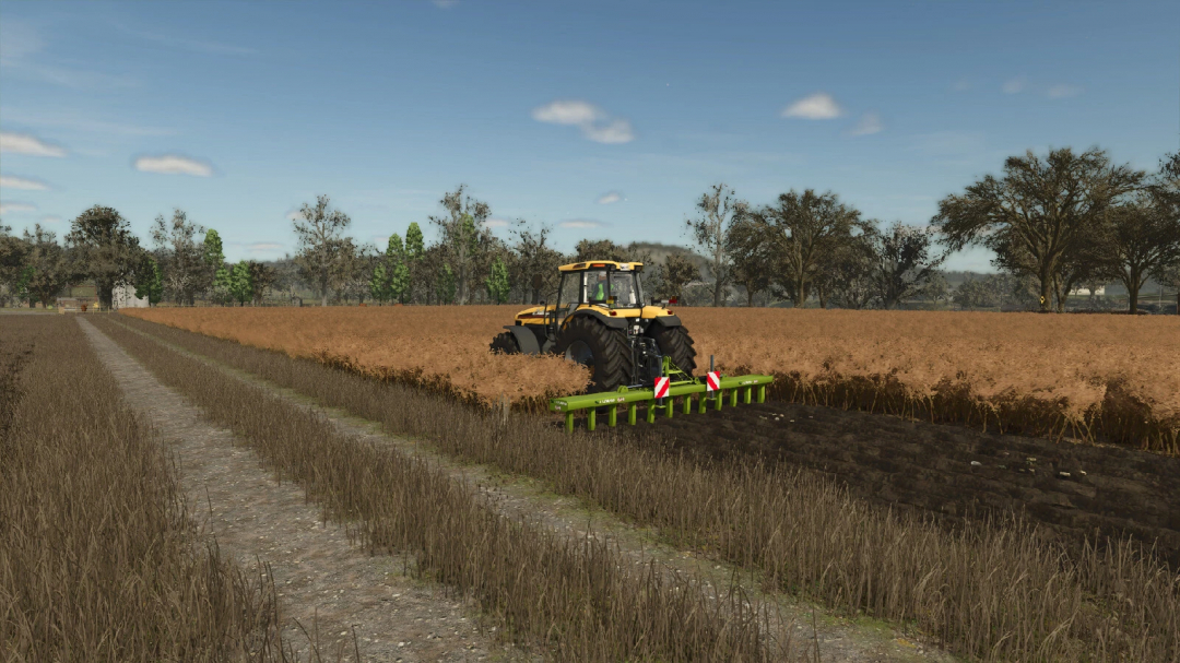 FS25 mod LIZARD 6M v1.0.0.0 showing a tractor plowing a field with trees in the background.