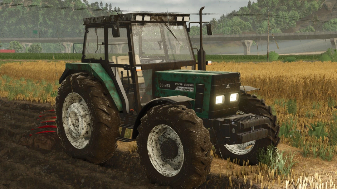 FS25 mod Mehmet Şimşeker 98-96 K tractor in a field, showcasing realistic muddy textures.