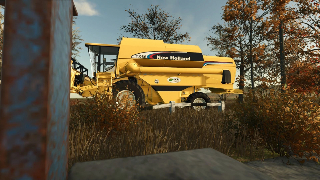 New Holland TX66 combine harvester in FS25 mod, showcasing autumn foliage setting.