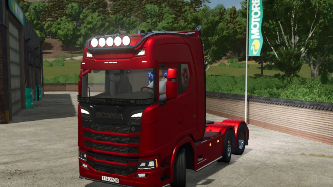 Red Scania S truck mod v1.0.1.0 in Farming Simulator 25 parked beside forest and building.