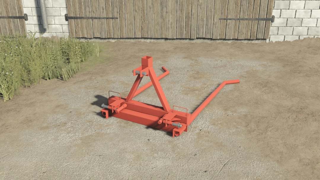 Self made bale fork mod for FS25 placed on concrete with barn background.