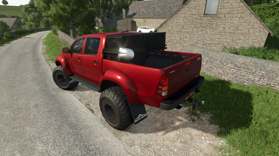 Toyota Hilux AT38 mod for FS25 parked on rural road