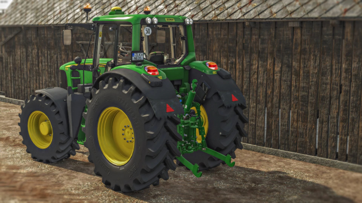 fs25-mods,  John Deere 7030 mod in FS25, showcasing a green tractor with yellow rims against a wooden barn backdrop.