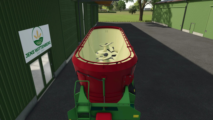 fs25-mods,  FS25 mod Strautmann Vertimix 3101 Double in front of green building in Farming Simulator 25.