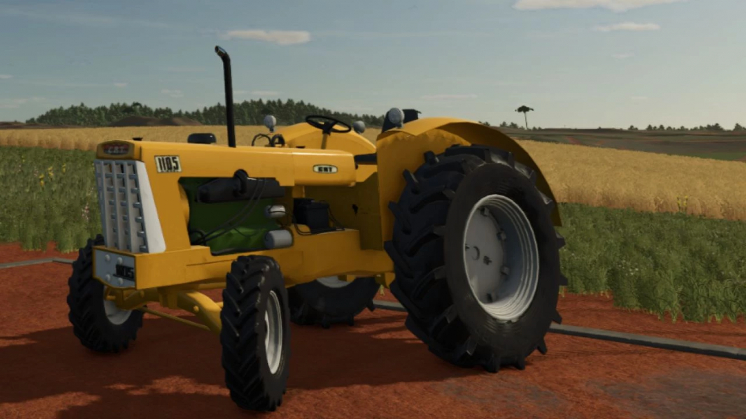 Yellow CBT 1105 BR tractor mod in FS25, parked on a farm road with fields in the background.