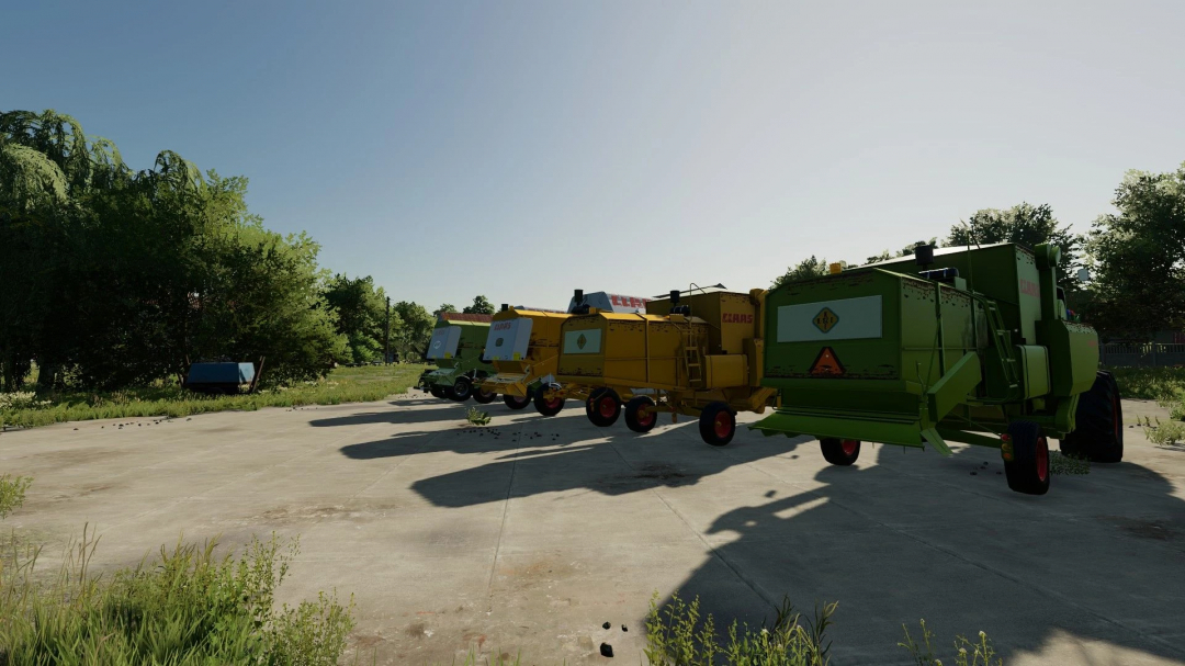 Row of CLAAS combine harvesters from FS22 mods on a sunny day in Farming Simulator 22.