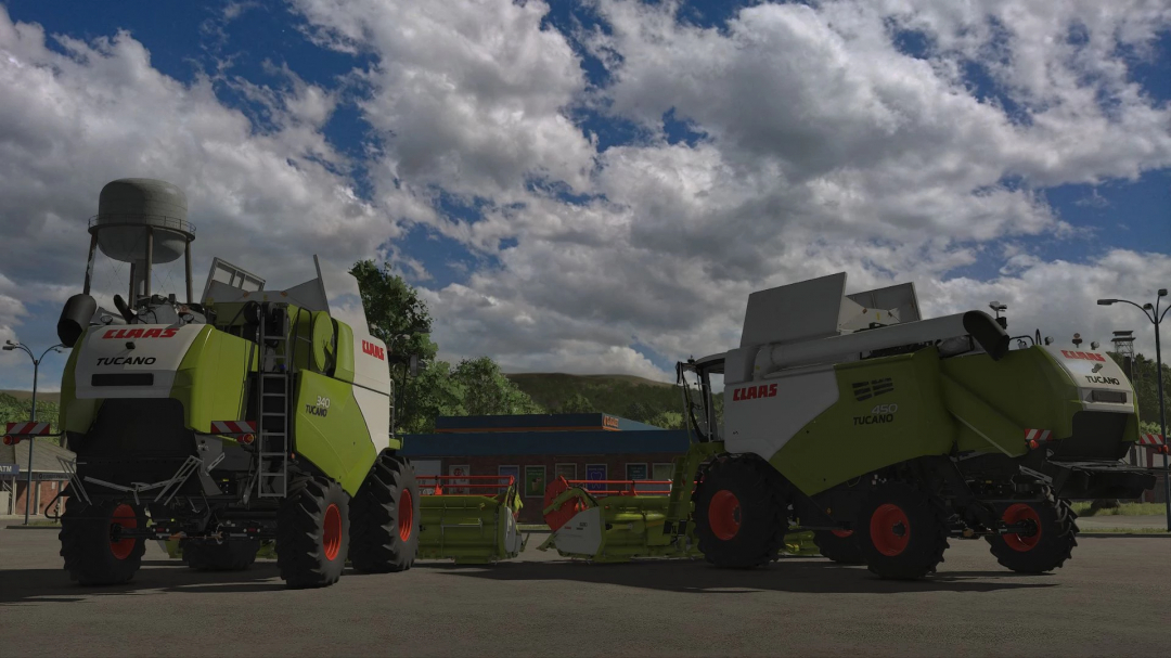 Two Claas Tucano harvesters in FS25 mod under cloudy sky.