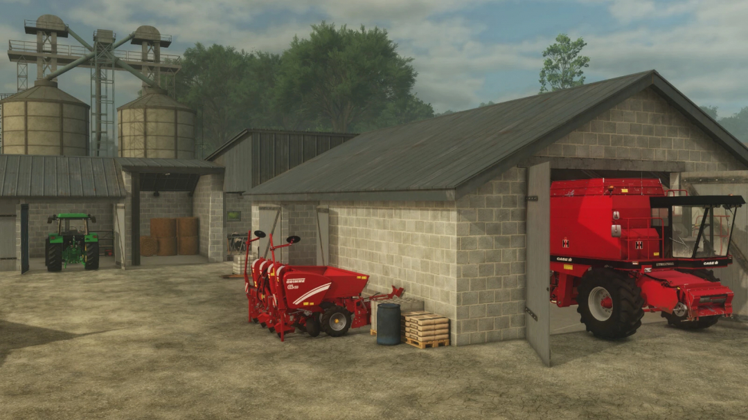 FS25 mod Cowshed with Garage v1.0.0.0 showing farm equipment parked in a garage and silos in the background.