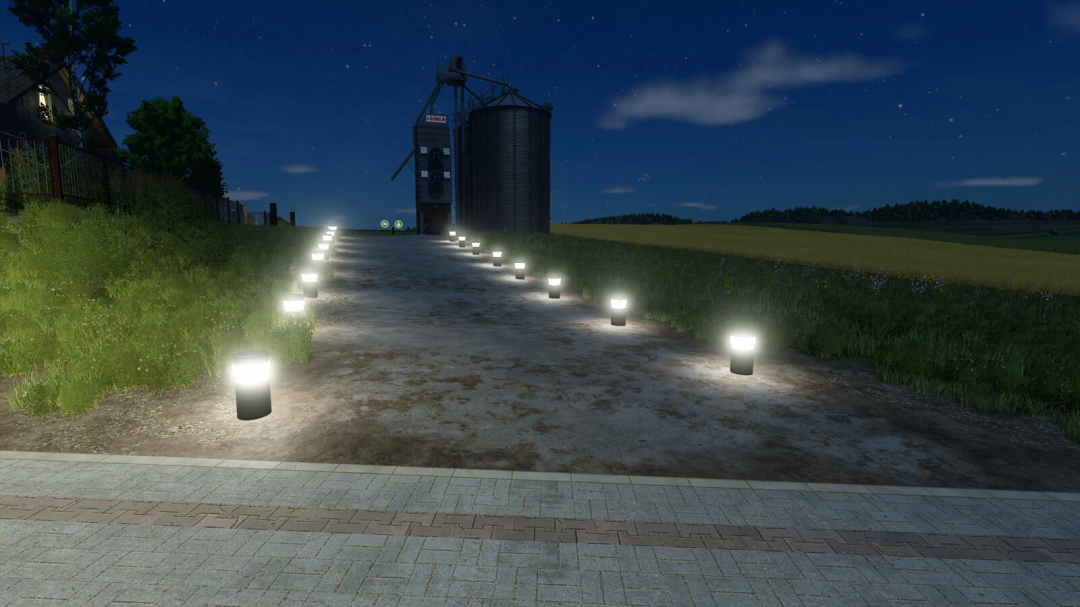 Night view of a path lined with garden lights near a silo in FS25 mods.