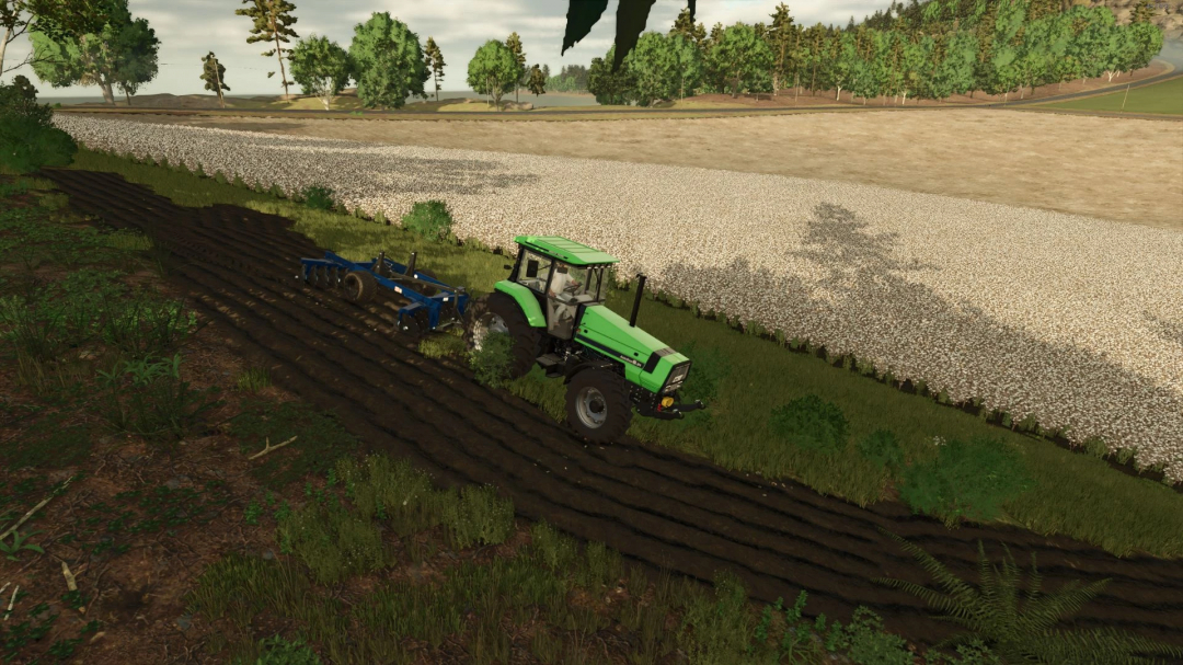 A tractor using Grade 18x24 discos BR mod in Farming Simulator 25, cultivating a field near a cotton crop.