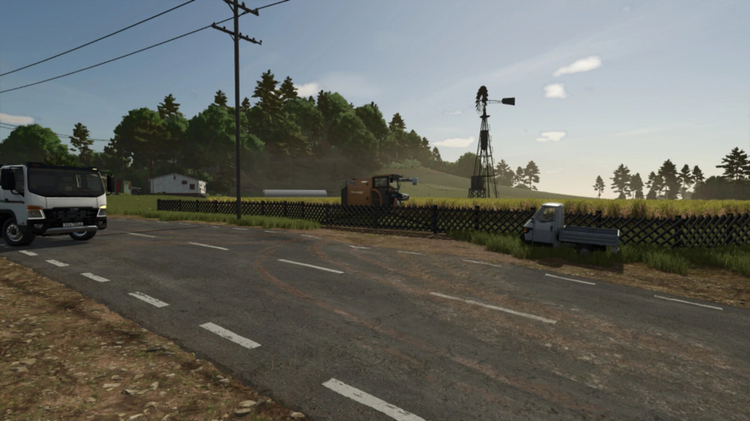 FS25 mod Hunter Fence v1.0.0.0 showcasing a rural road with vehicles, trees, and a windmill in the background.