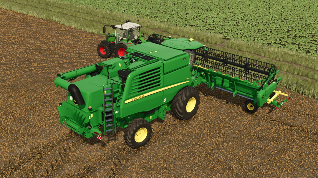 John Deere T-Series with 600X Headers mod in FS25, featuring a green combine harvester on a harvested field.