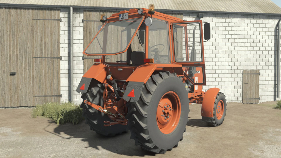 MTZ-82 NAREW tractor mod for Farming Simulator 25 parked in front of a barn.