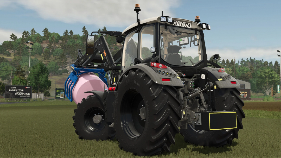 Tractor with front loader carrying a pink bale in FS25 Weight Pack mod.