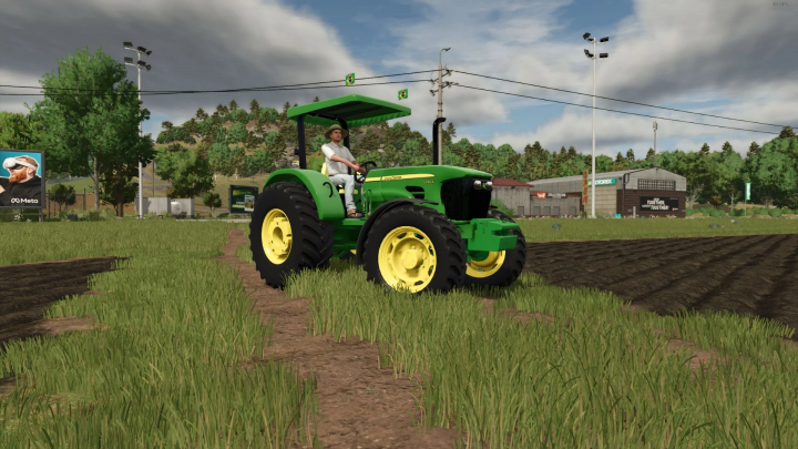 fs25-mods,  A farmer drives a John Deere 50E Series tractor in FS25 mod, Farming Simulator 25, on a field with lush greenery.