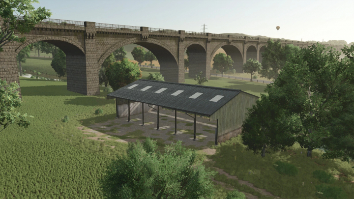 fs25-mods,  FS25 Pallegney Buildings Pack mod with a rustic building under a large bridge, surrounded by trees.